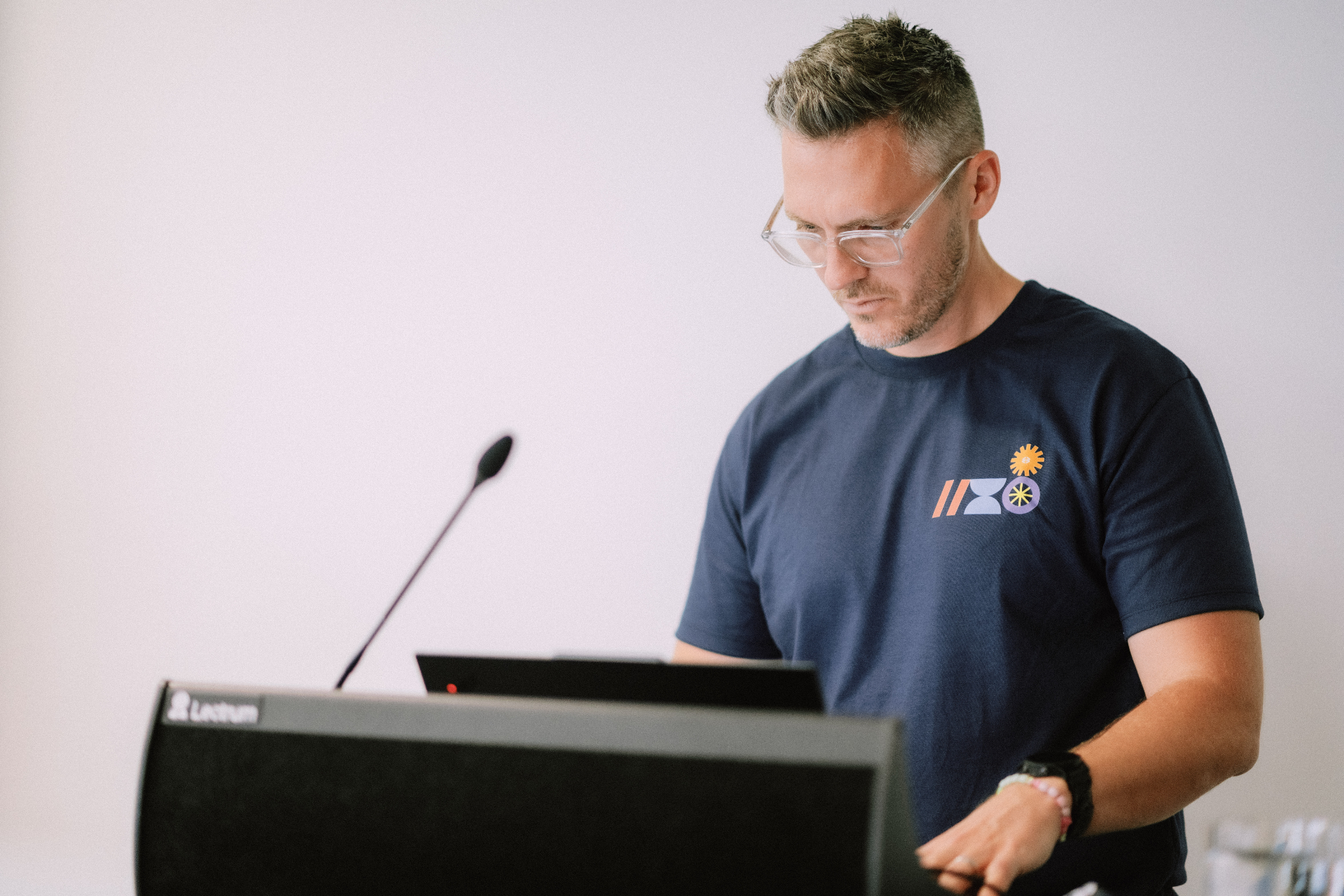 A Wize Marketing presenter preparing at a lectern