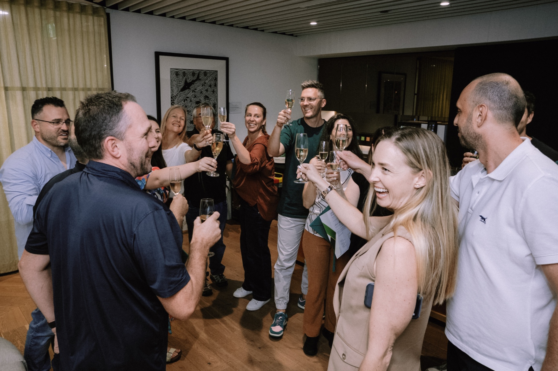 WizeAdvisory members celebrating together at a live workshop