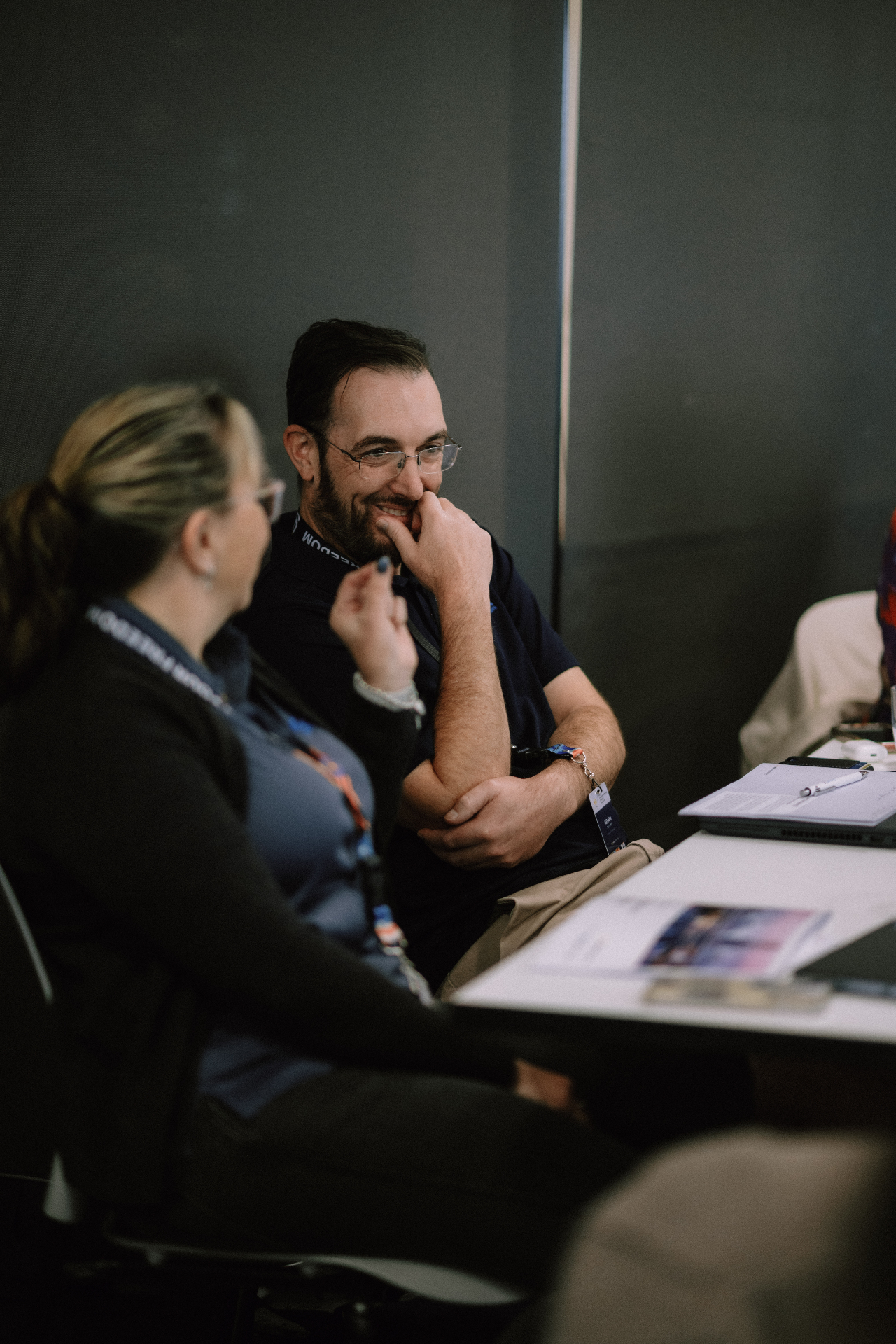 Participants sharing a light moment during a Day 1 table discussion