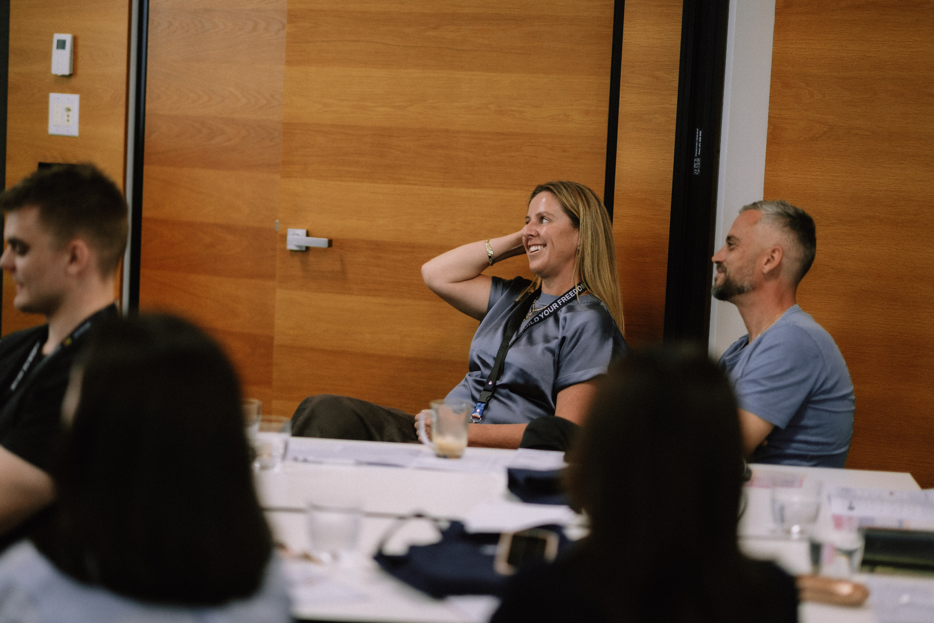 Attendees smiling during a seated Day 1 workshop discussion