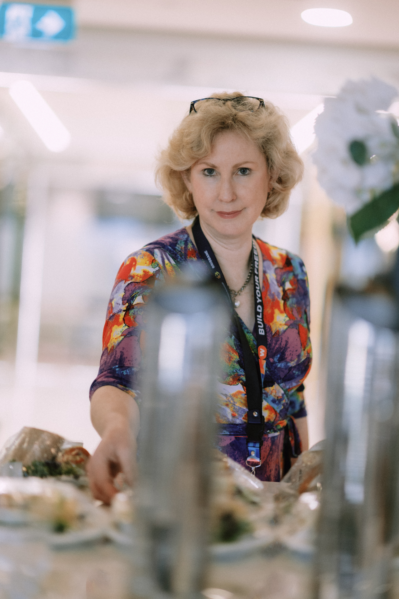 Attendee reaching across the catering table during the May 25 Day 1 event