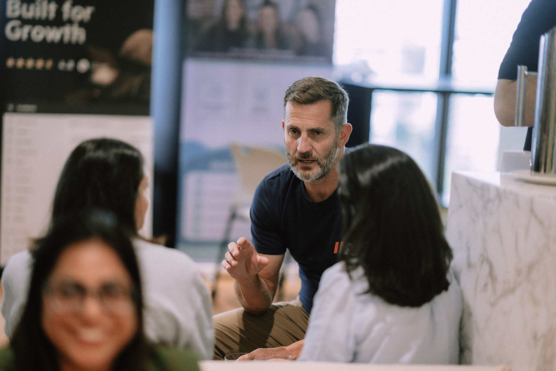 Wize team member speaking with attendees during the May 25 Day 1 networking break