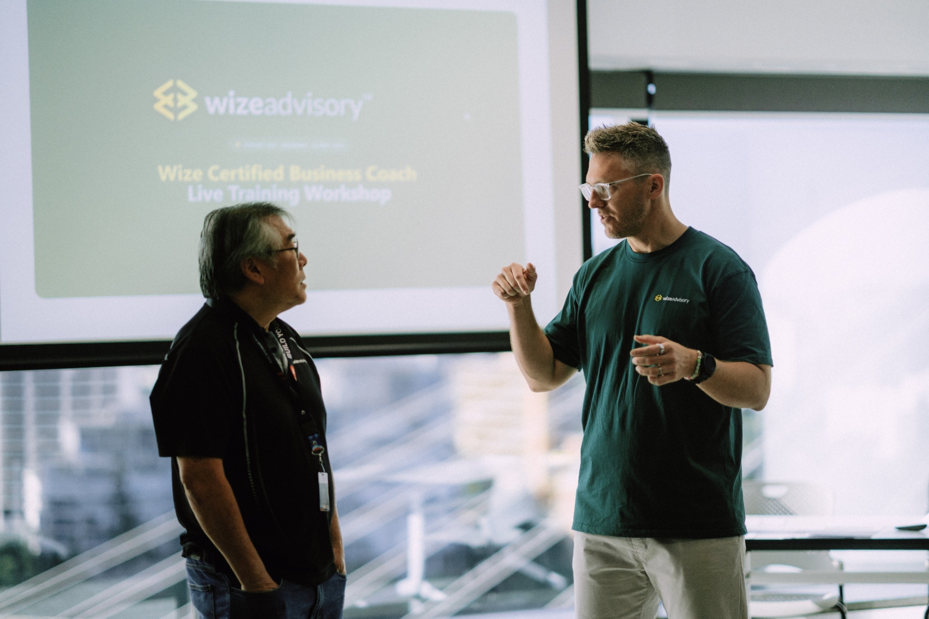 A WizeAdvisory coach speaking with a workshop member
