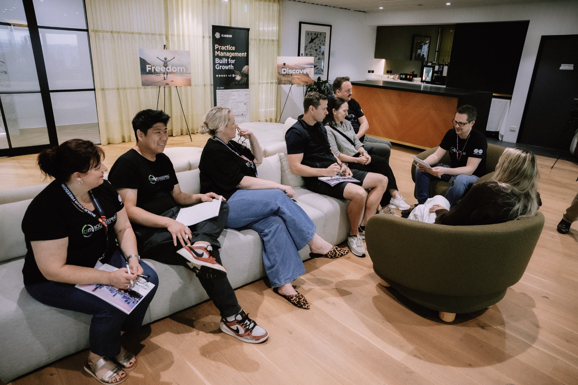 Small breakout discussion in the lounge area during the Day 4 Wize Intensive