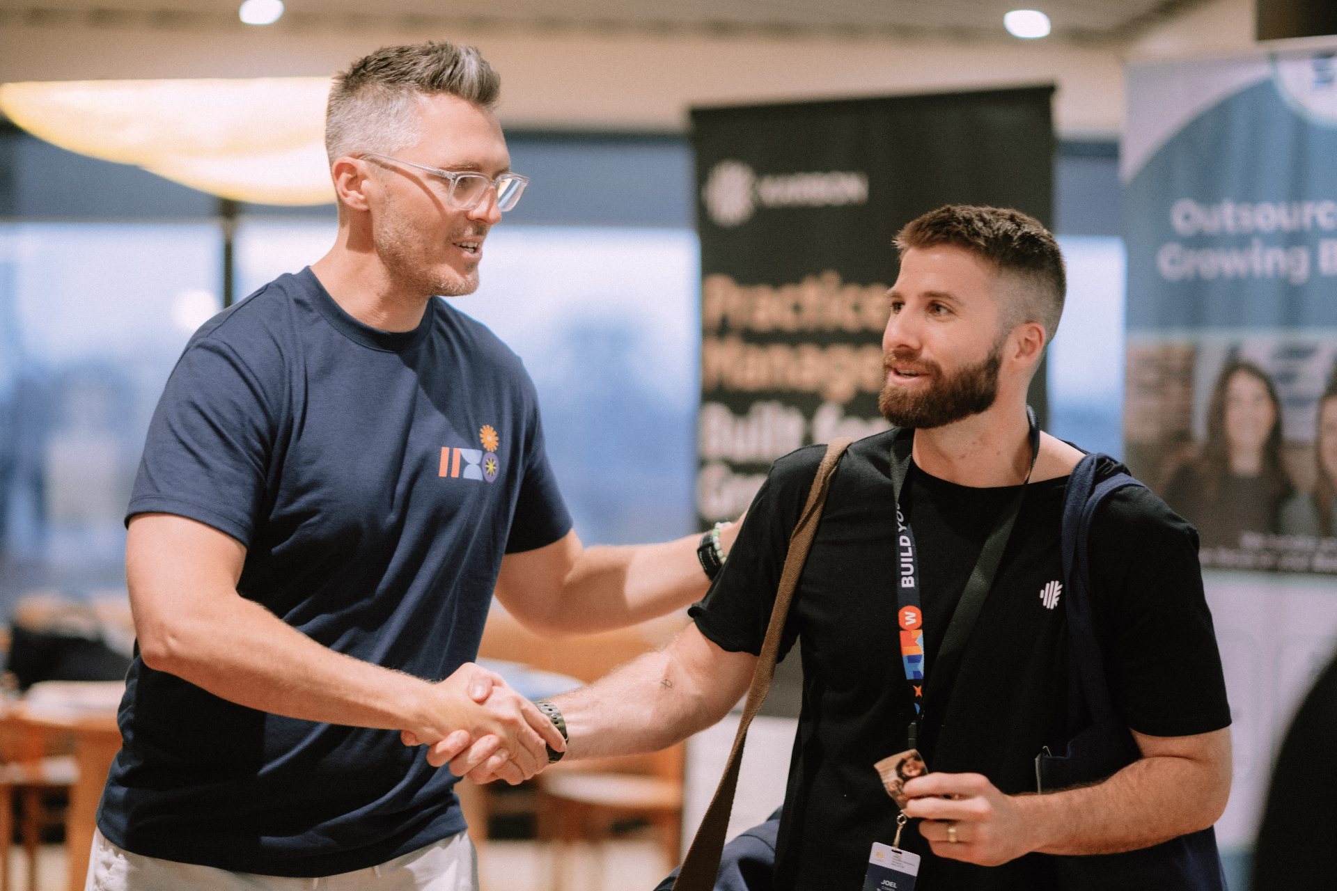 Handshake between attendees during the May 25 Day 1 Wize Intensive