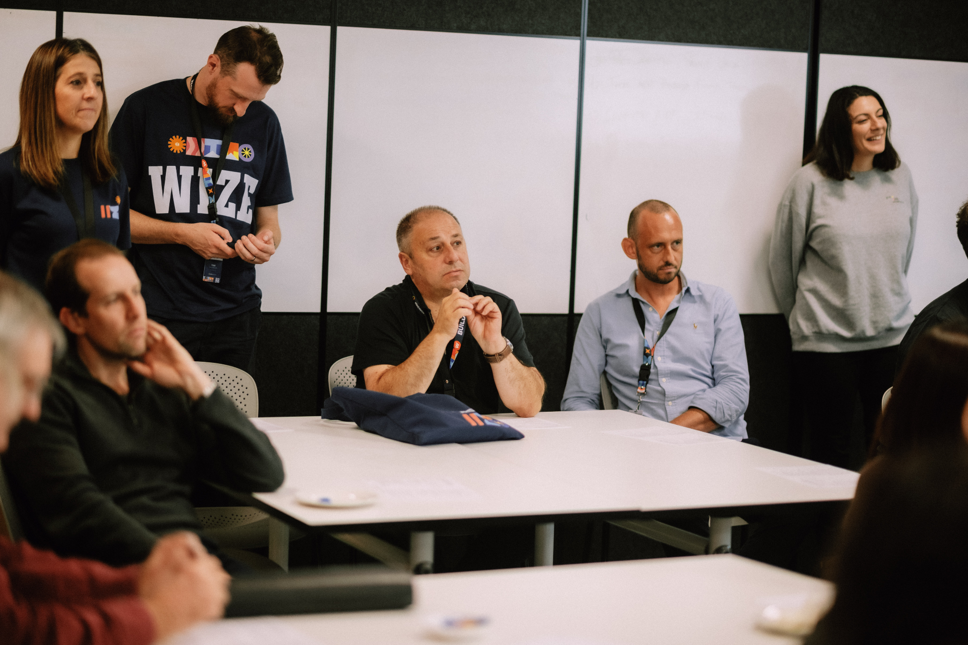 Wize team members and attendees gathered around the table during a Day 4 discussion