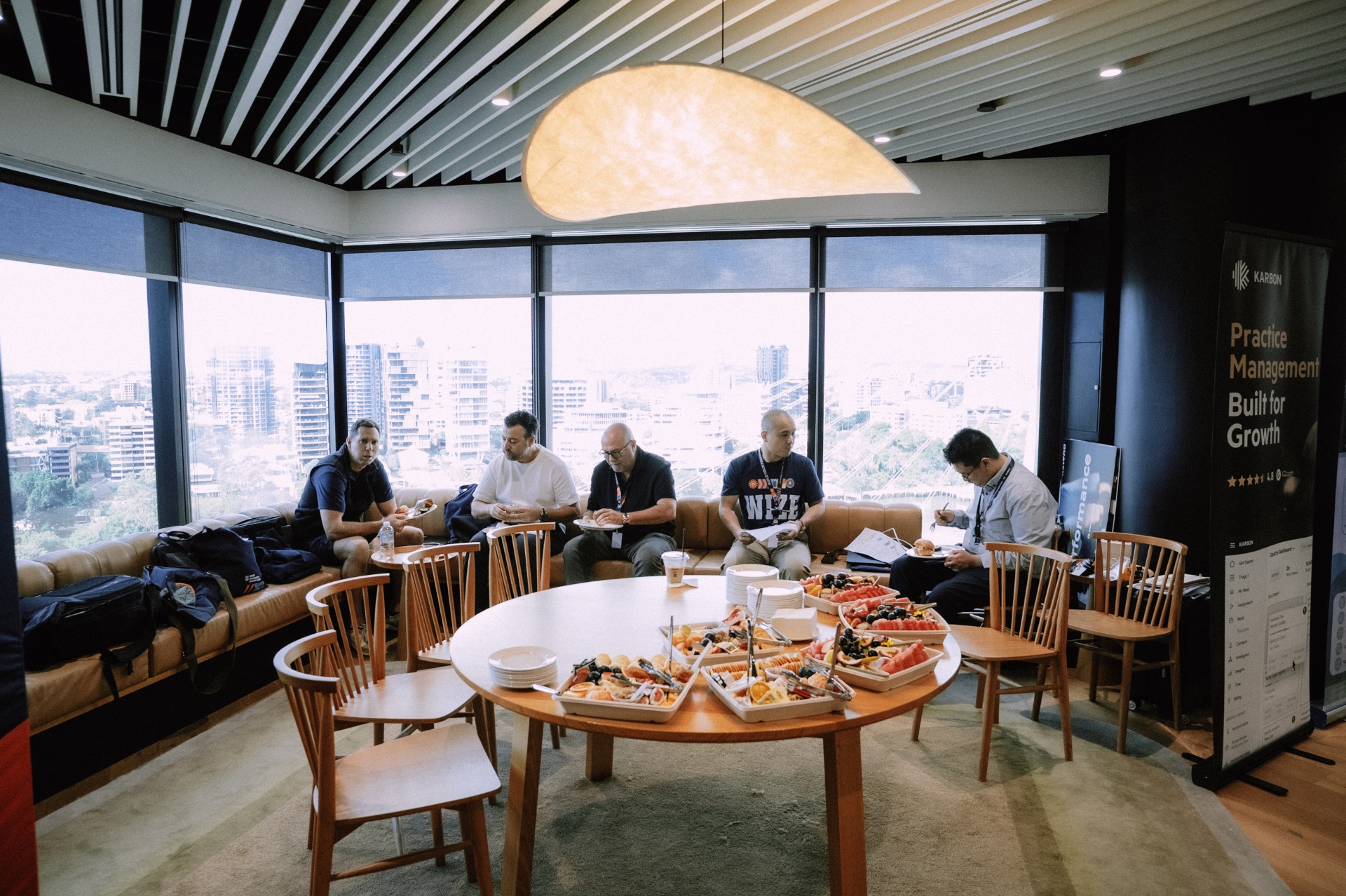 Attendees relaxing with food by the window