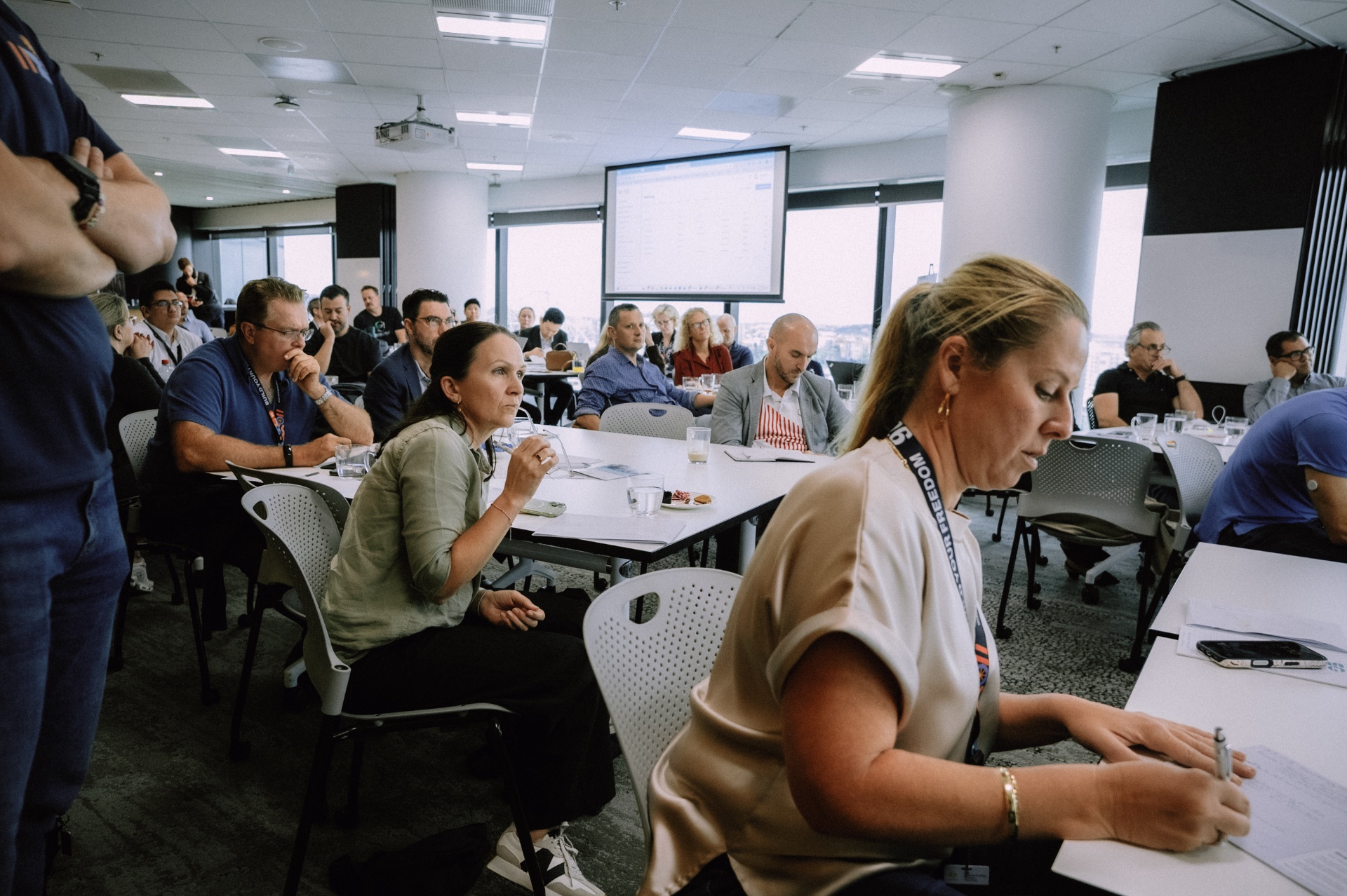 Wide view of attendees taking notes and engaging during the Day 4 workshop