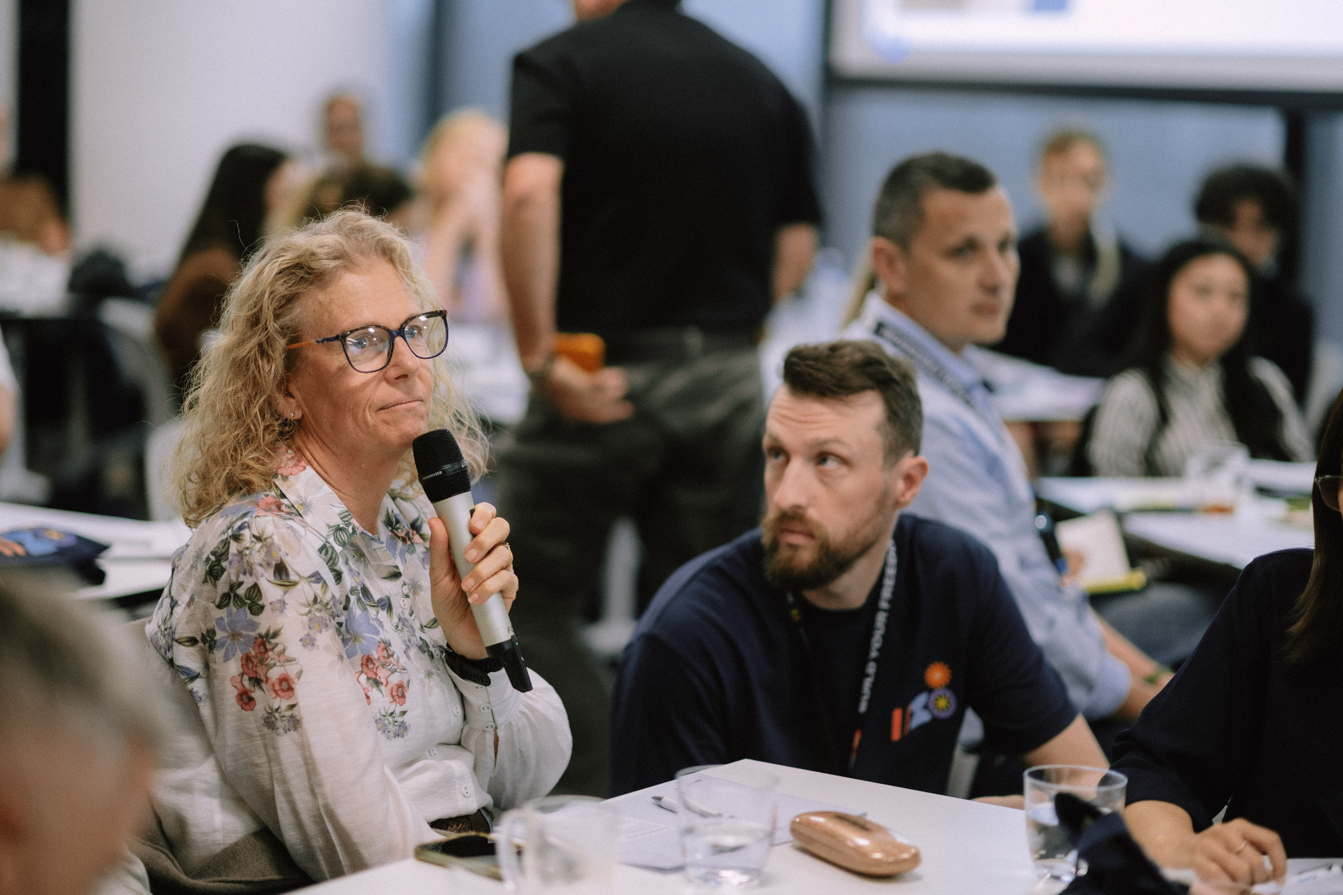 Audience member speaking with a microphone during the workshop session