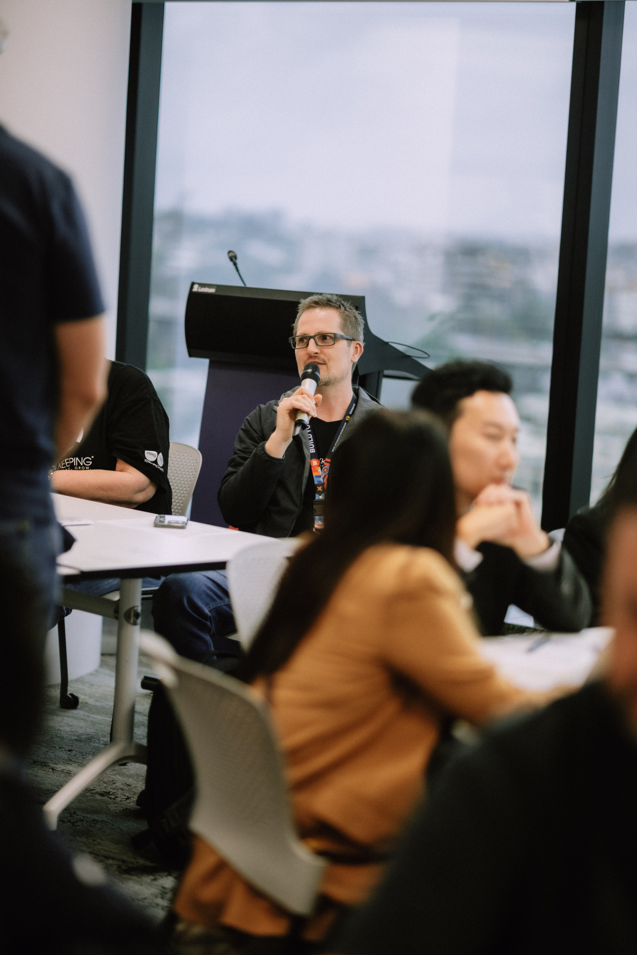 Attendee asking a question with the microphone during the Day 4 session
