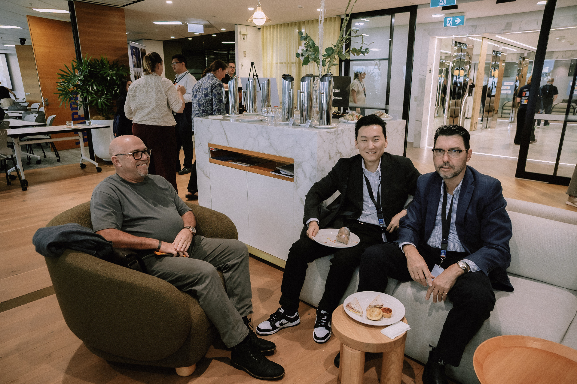 Three attendees seated in the lounge area during networking at the Day 4 workshop