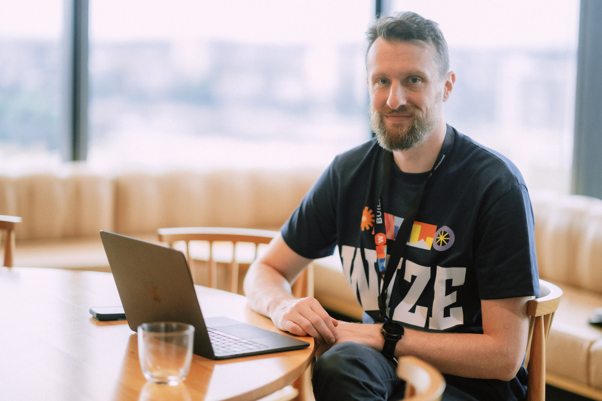 Wize team member seated with a laptop in the lounge area during the Day 4 workshop