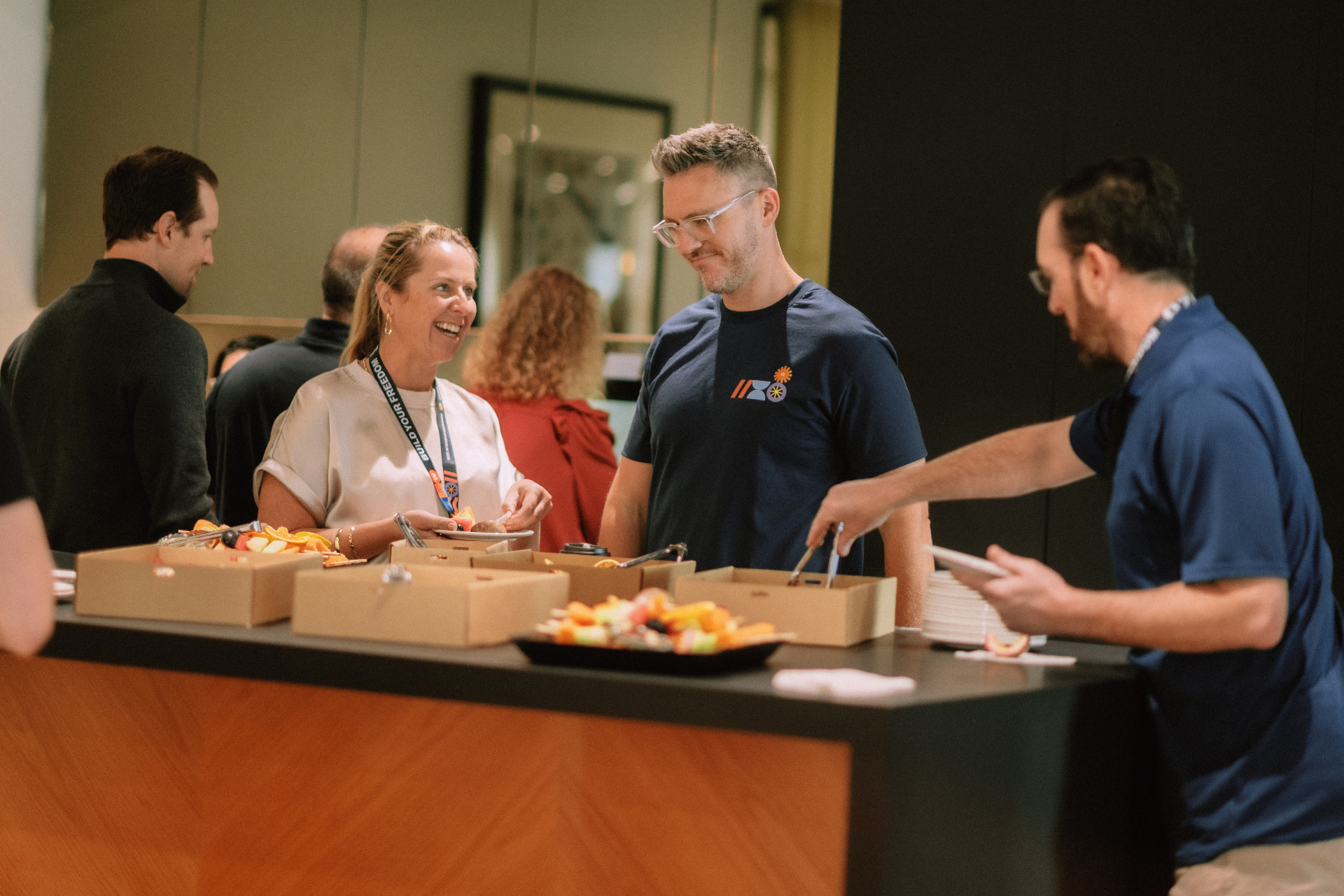 Attendees chatting over fruit and pastries during the Day 4 coffee break