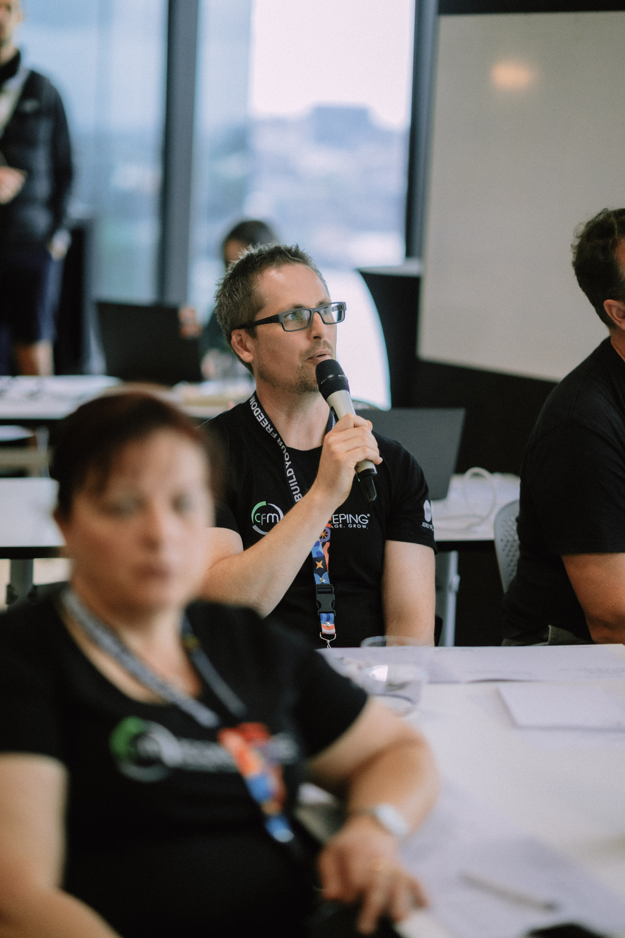 Attendee speaking into the microphone during the Day 4 Q and A session