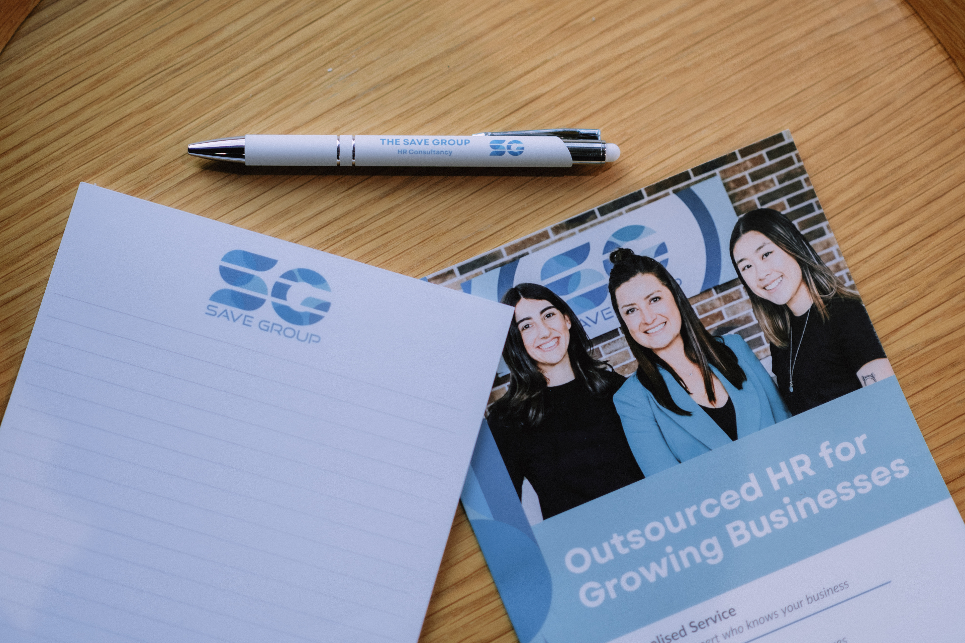 Save Group branded notebook, brochure, and pen at the event