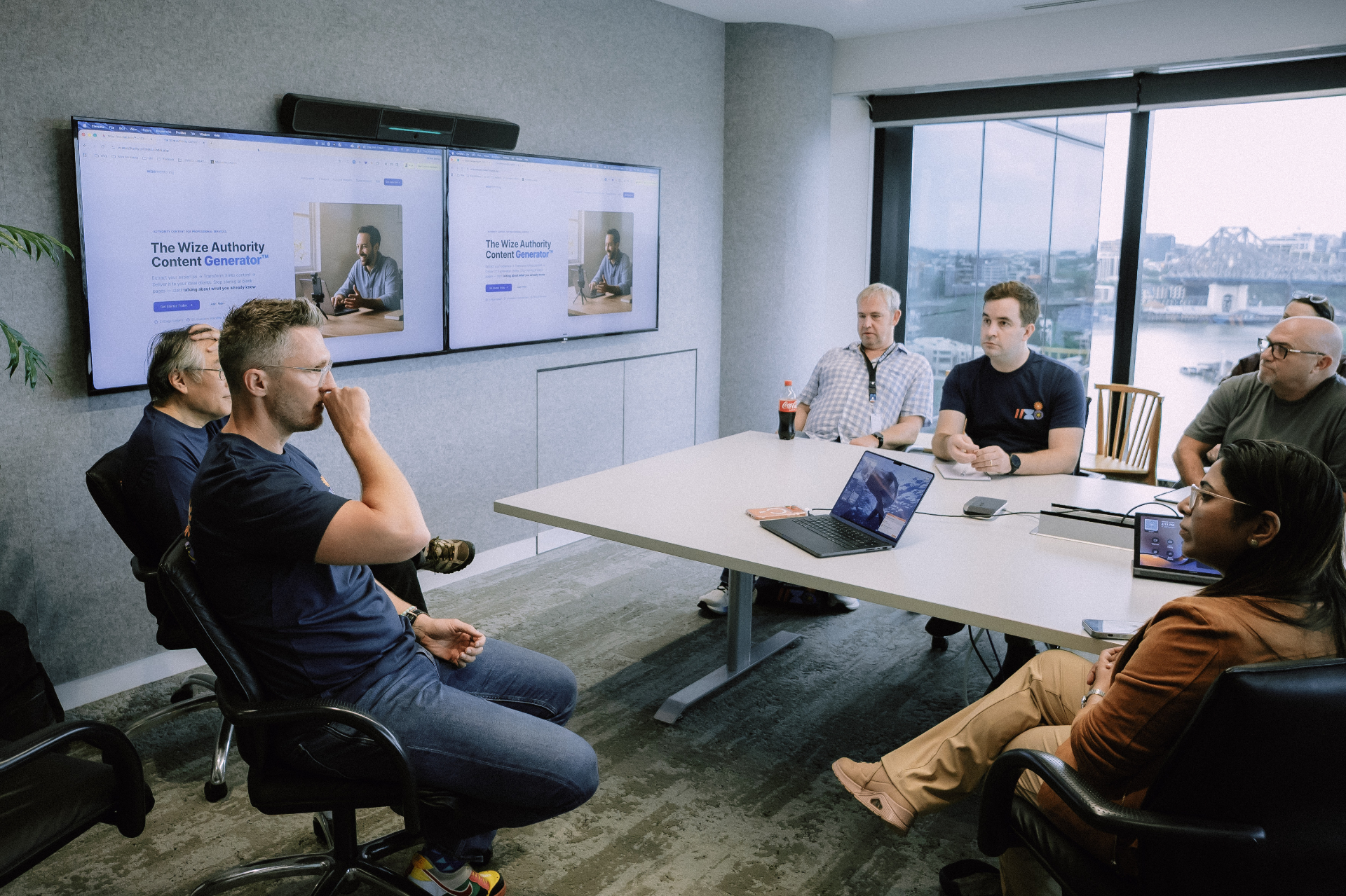 Attendees gathered around a meeting table during a Day 4 breakout session