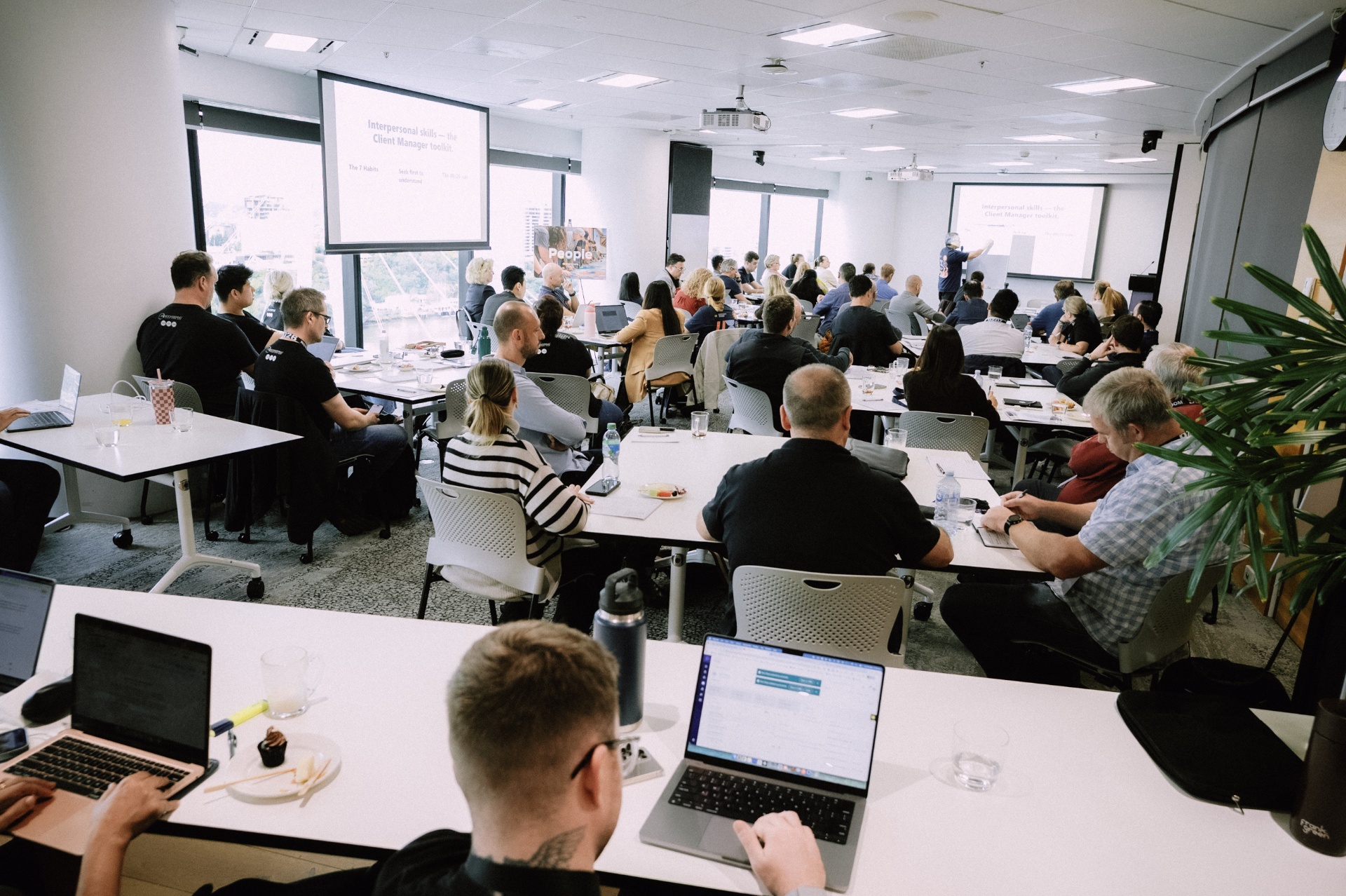 Full workshop session in progress with attendees focused on the presentation