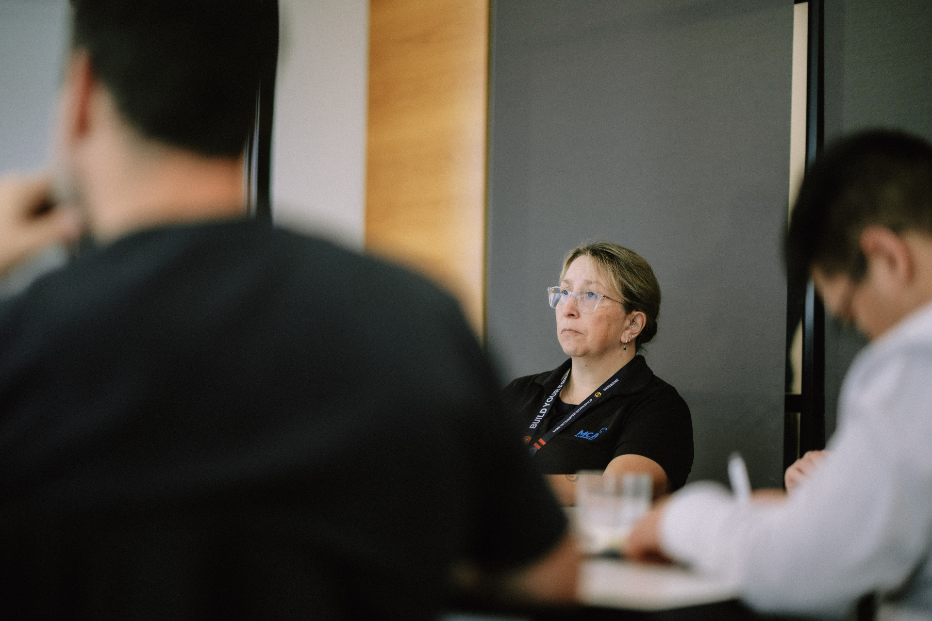 Attendee listening attentively during a Day 4 workshop discussion