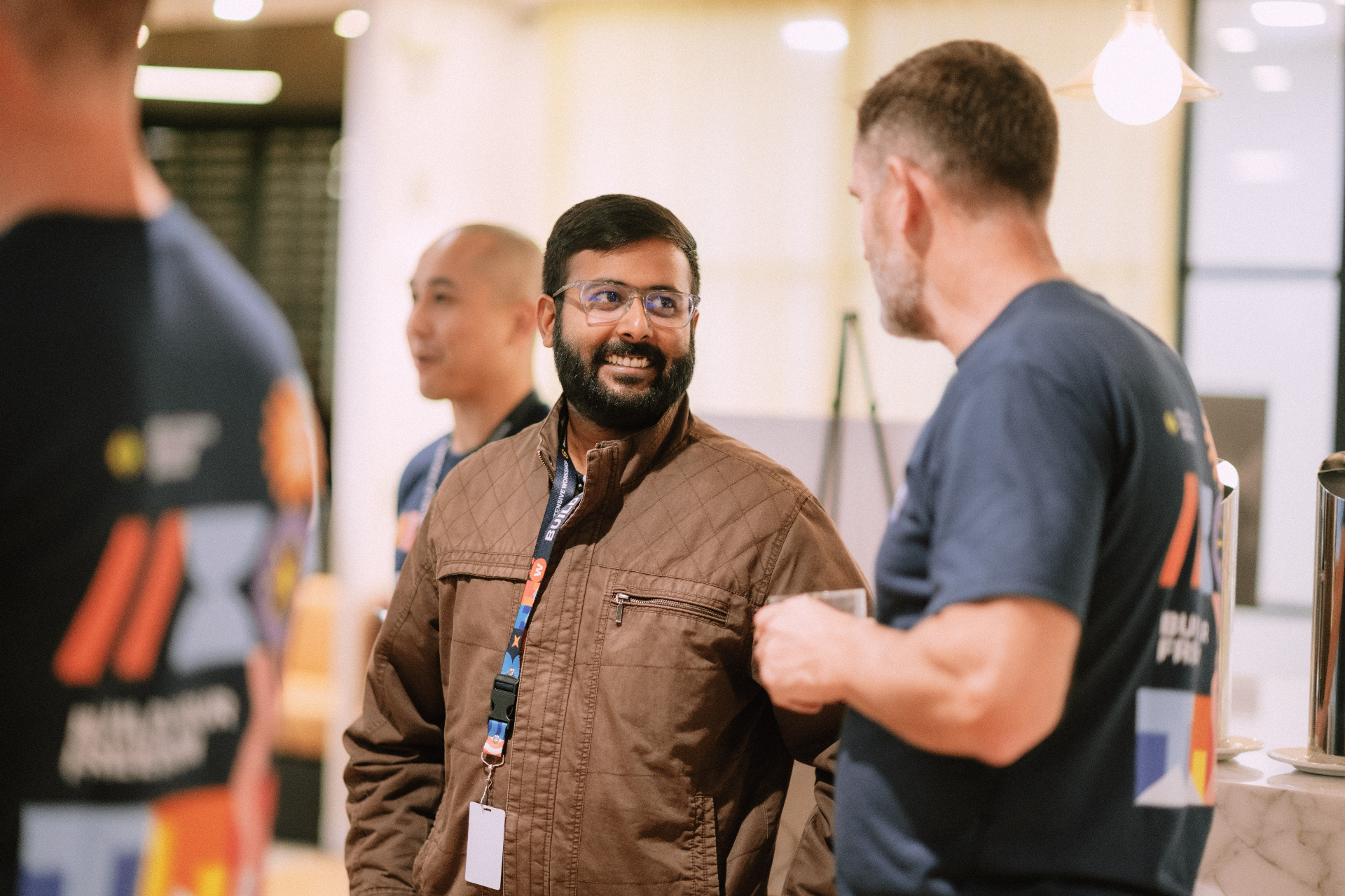 Attendee chatting with Wize team members during a Day 1 networking break