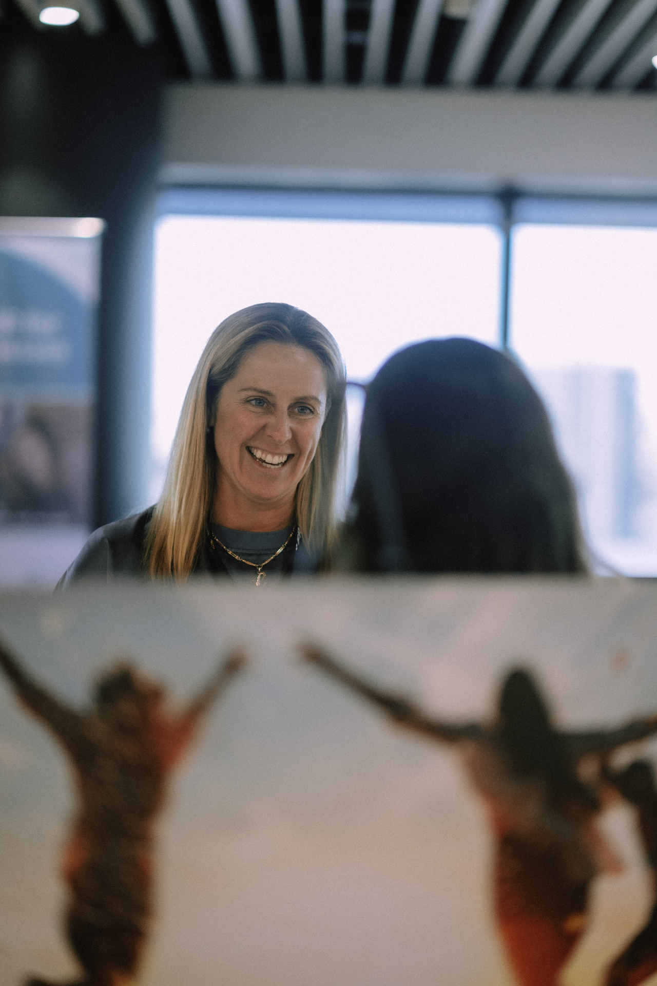 Smiling attendee in conversation during the May 25 Day 1 Wize Intensive